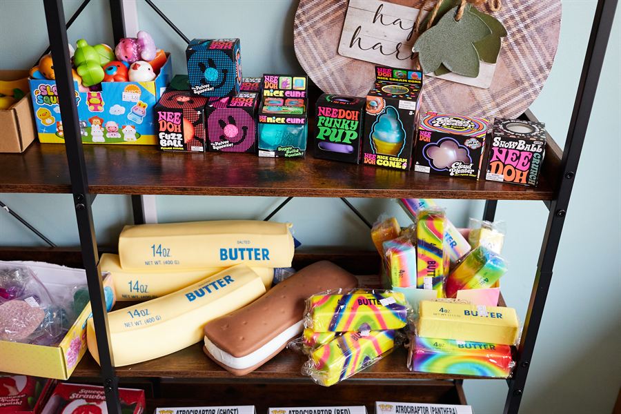 A shelf of colorful fidget toys and squishies