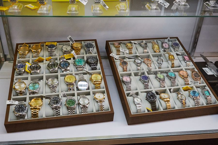 Two trays of wristwatches in the display case