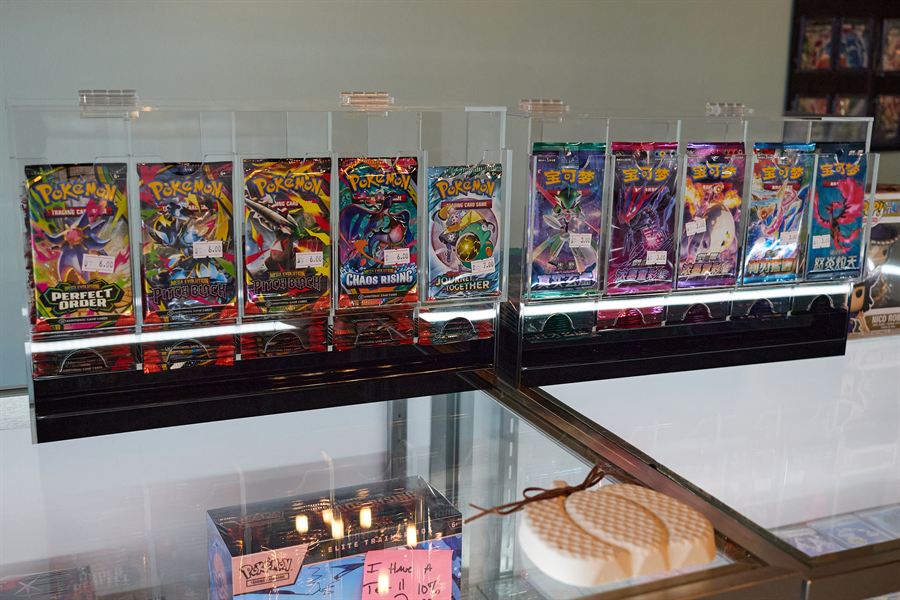 Pokémon booster packs displayed on top of a glass counter